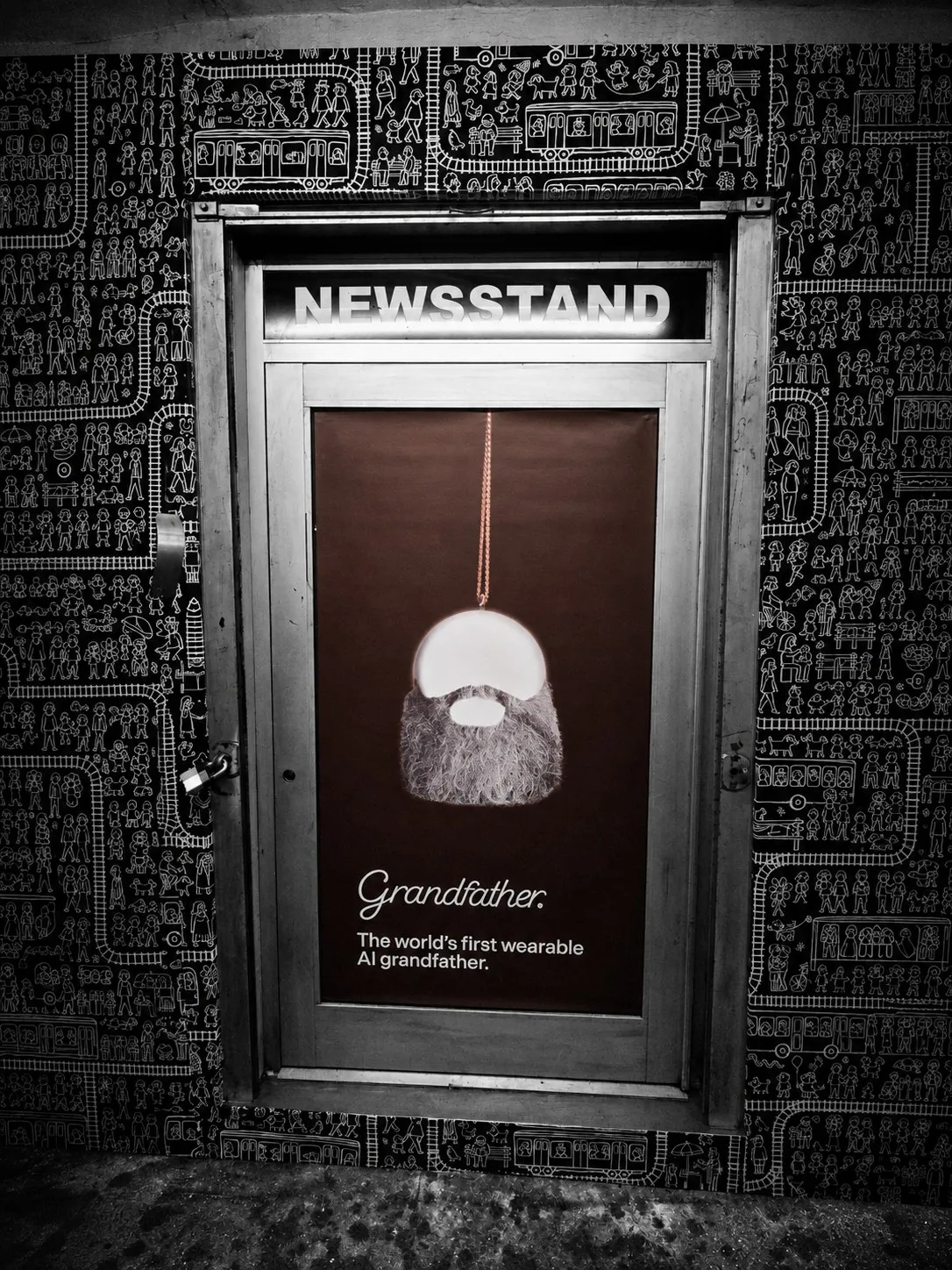 A poster for Grandfather, the world’s first wearable AI grandfather, glowing inside a locked newsstand door beneath a lit NEWSSTAND sign